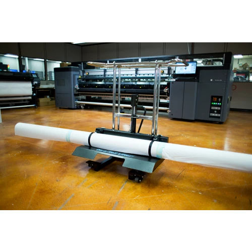 Foster on a roll lifter facing the left with an HP Latex 3000 in the background