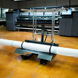 Foster on a roll lifter facing the left with an HP Latex 3000 in the background